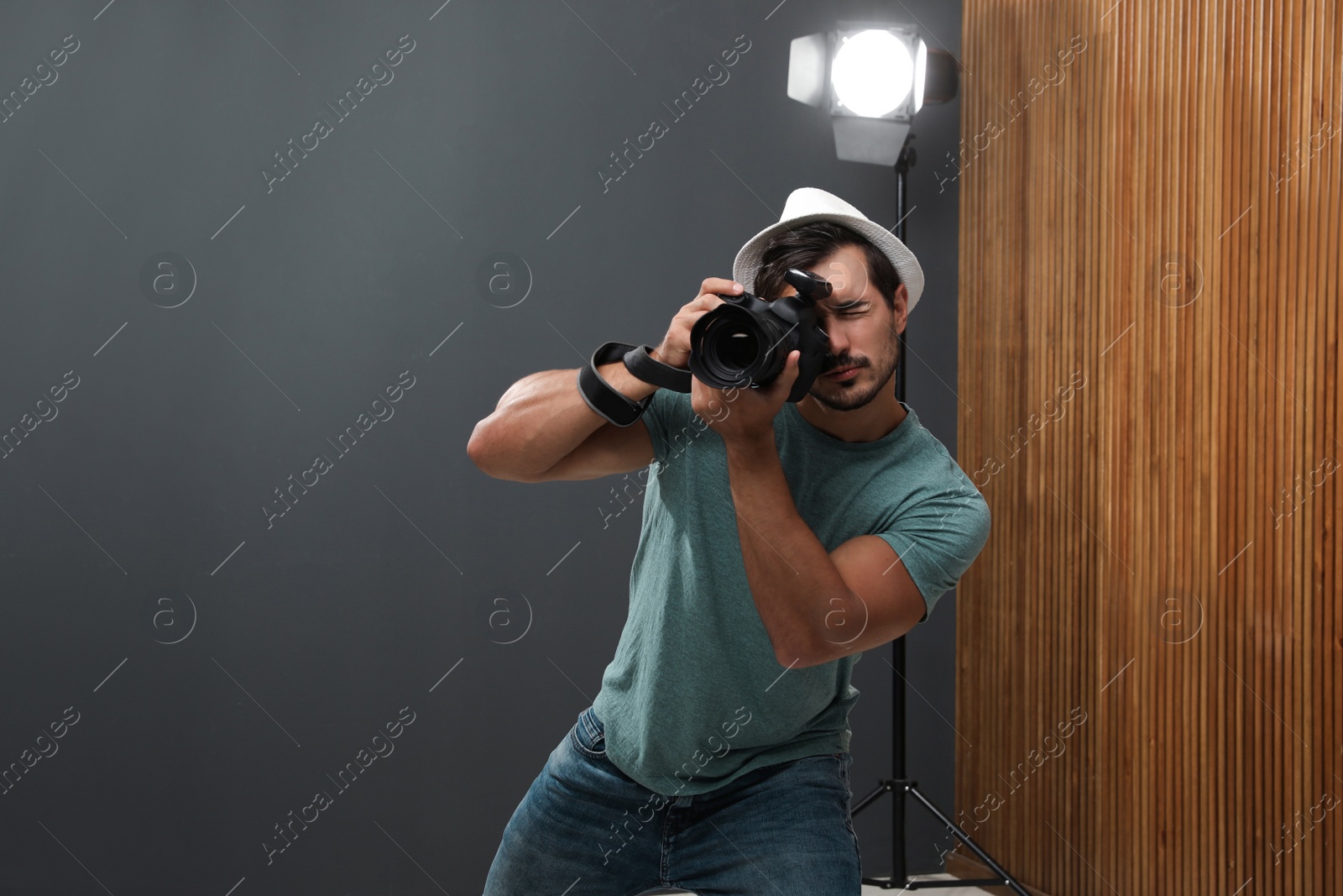 Photo of Professional photographer taking picture in modern studio