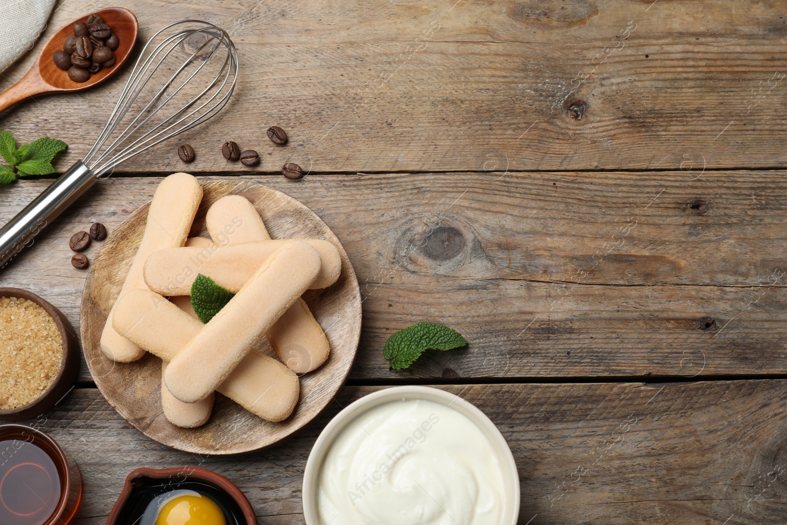 Photo of Flat lay composition with tiramisu ingredients on wooden table, space for text