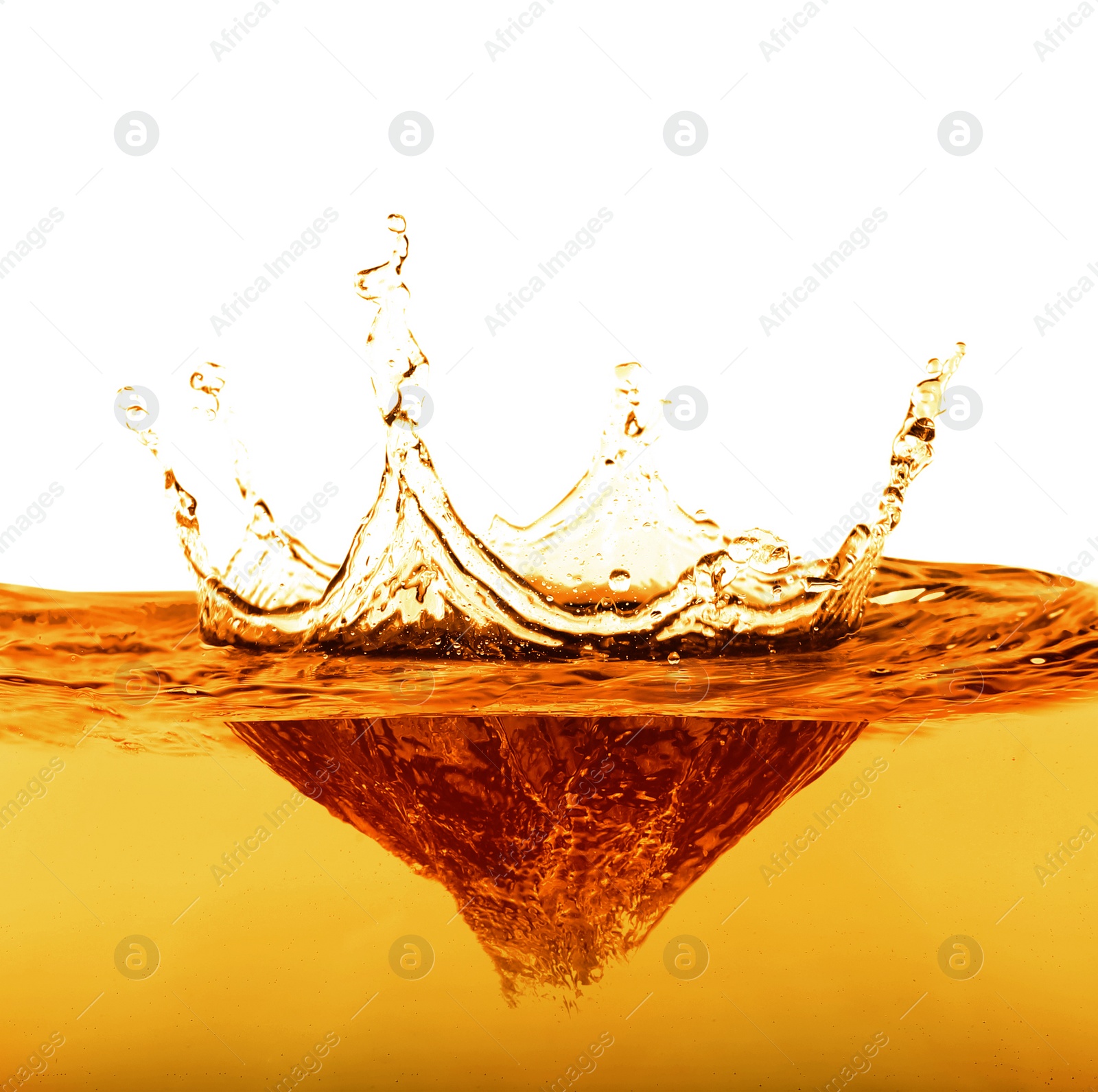 Image of Golden oily liquid splash on white background