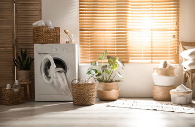 Photo of Stylish room interior with washing machine. Design idea