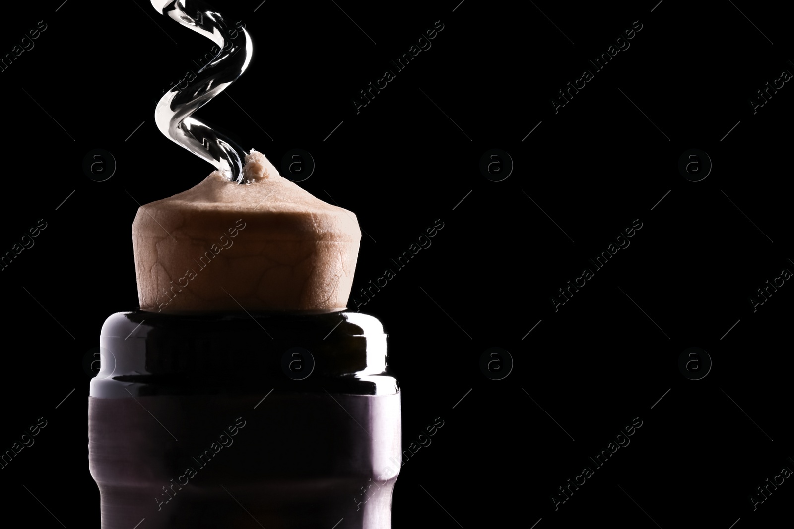 Photo of Opening wine bottle with corkscrew on dark background, closeup. Space for text