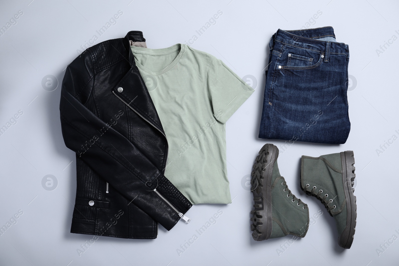 Photo of Stylish outfit with jeans on light grey background, flat lay