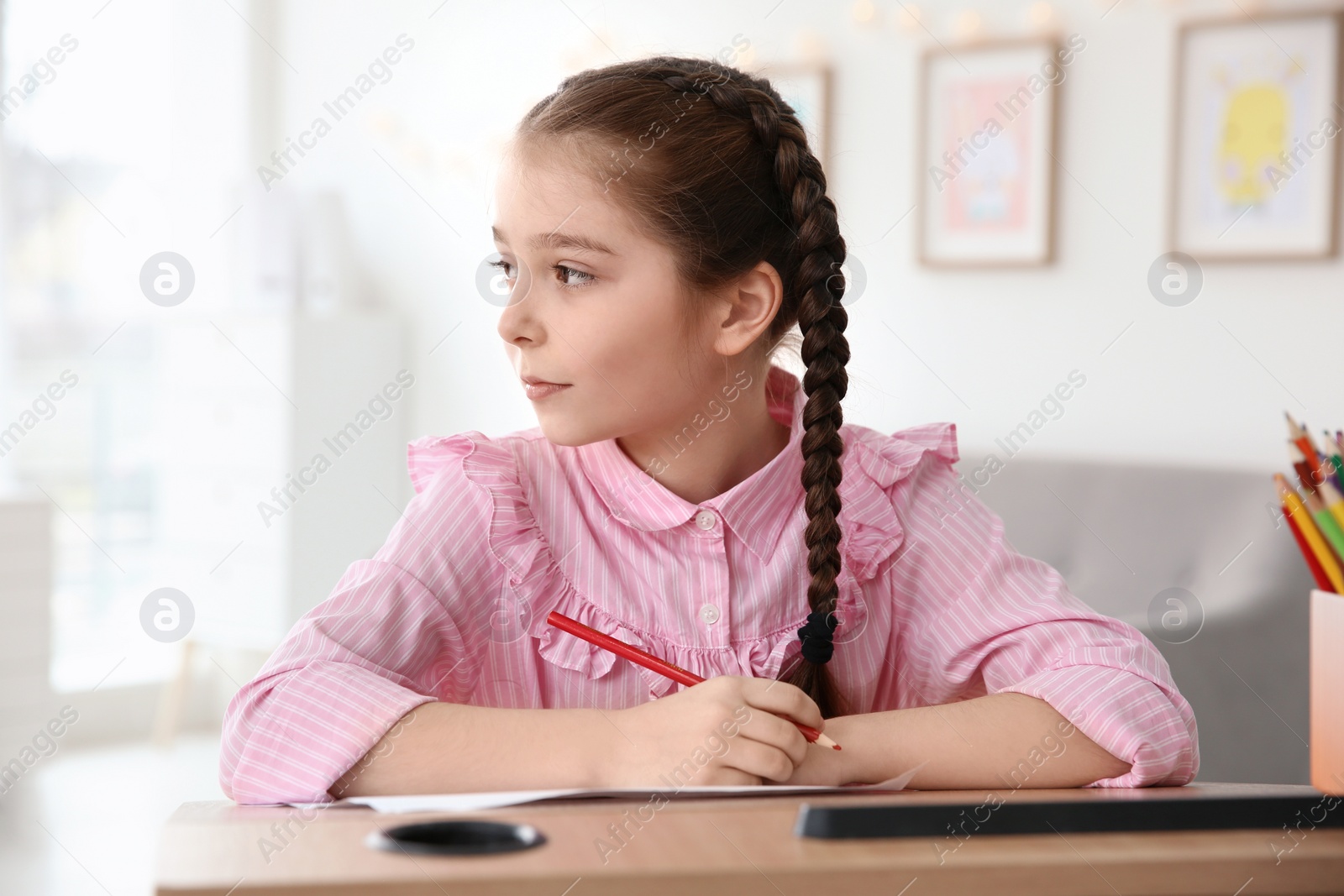 Photo of Little girl with autistic disorder drawing at home