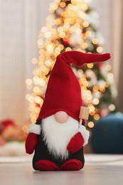 Cute Christmas gnome on floor in decorated room