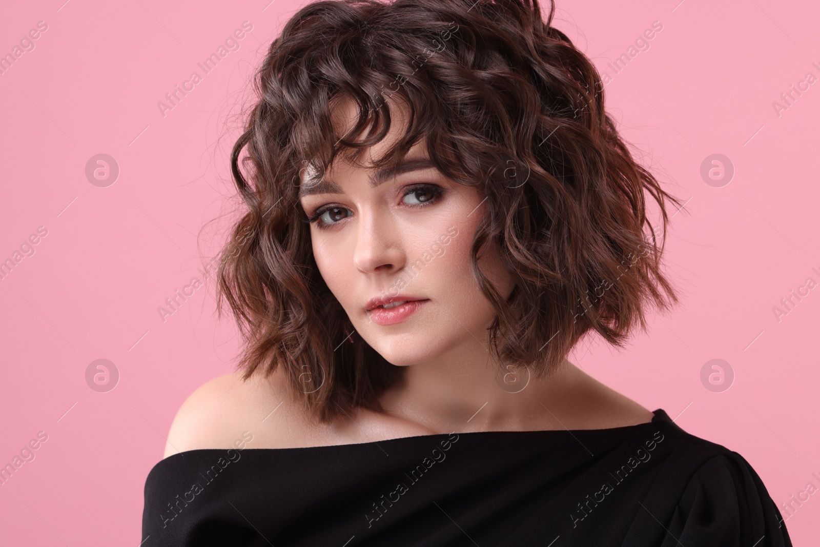 Photo of Beautiful young woman with wavy hairstyle on pink background