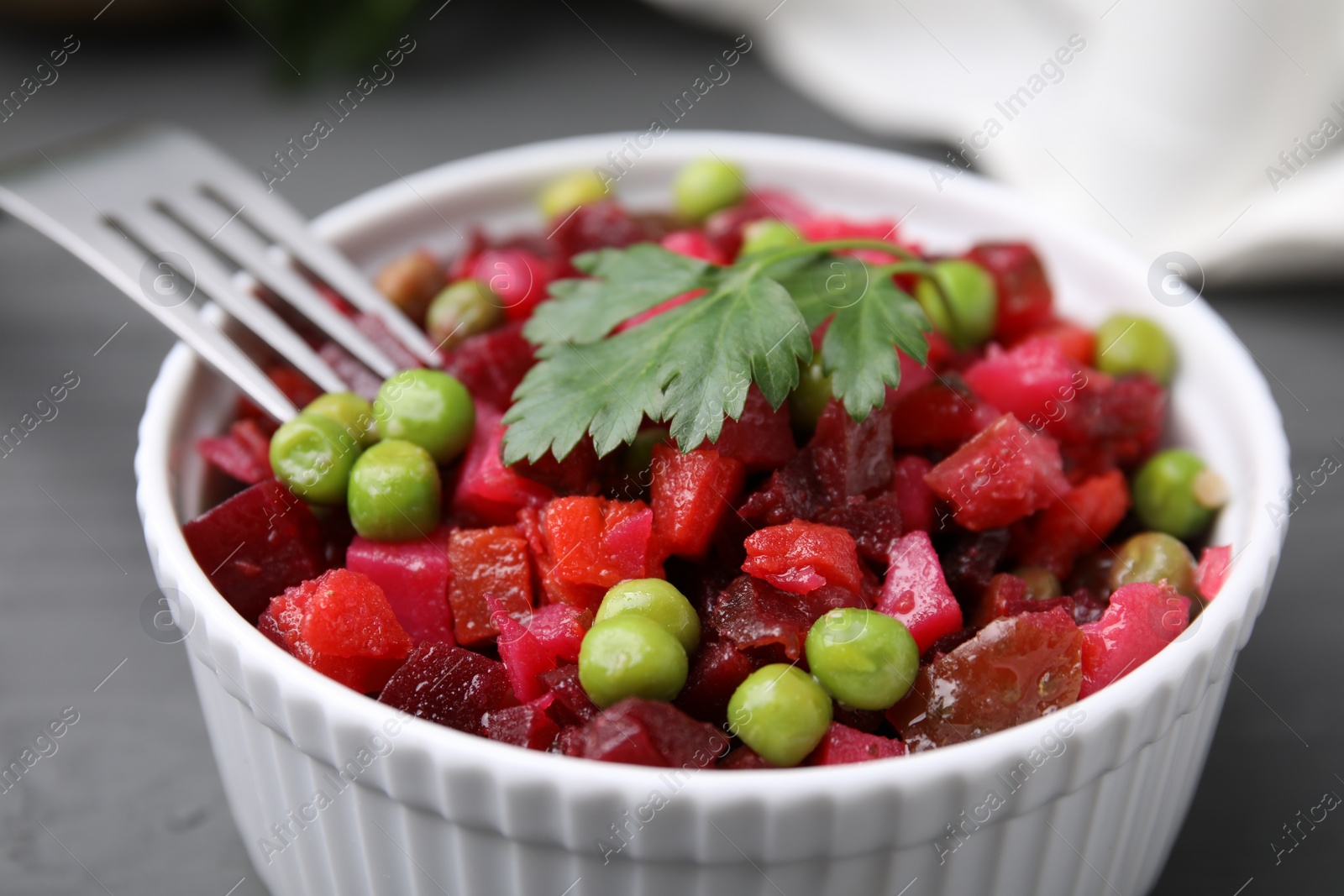 Photo of Delicious vinaigrette salad on grey table, closeup