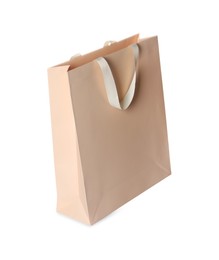 Photo of One beige shopping bag isolated on white