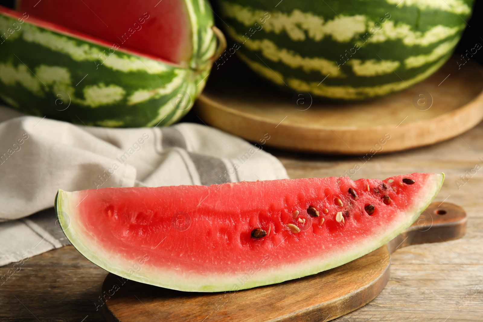 Photo of Board with yummy watermelon slice on wooden table