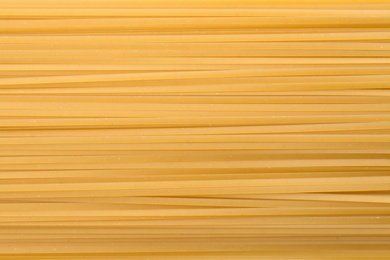 Photo of Uncooked pasta as background, closeup