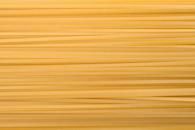 Uncooked pasta as background, closeup