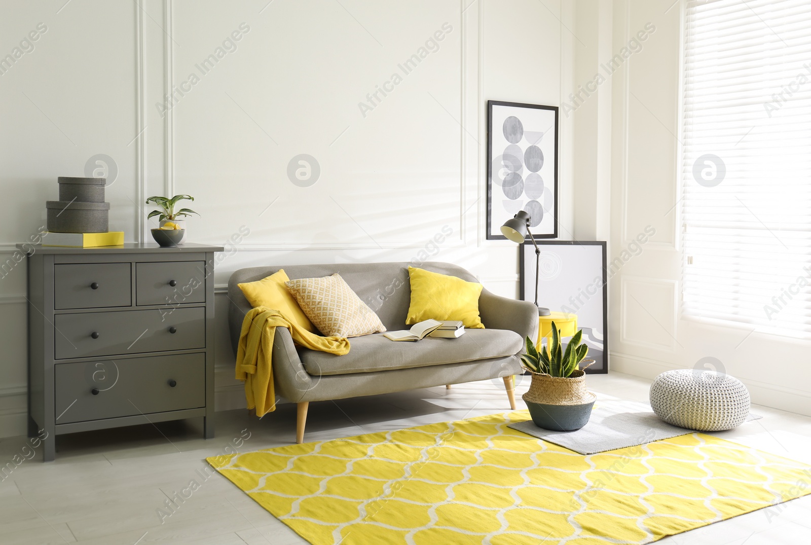 Photo of Stylish living room with sofa. Interior design in grey and yellow colors