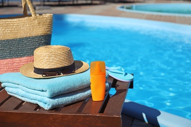 Beach accessories near swimming pool on sunny day