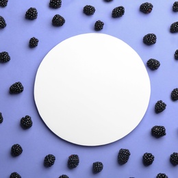 Fresh blackberries and blank card on lilac background, flat lay. Space for text