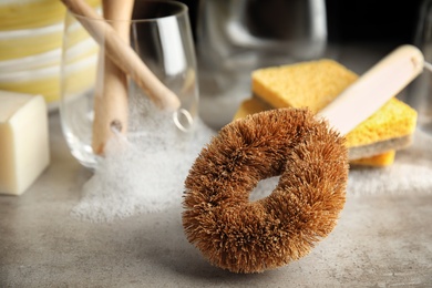 Photo of Cleaning brush for dish washing on grey table, closeup