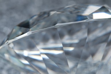 Photo of Large dazzling brilliant on shiny silver surface, closeup