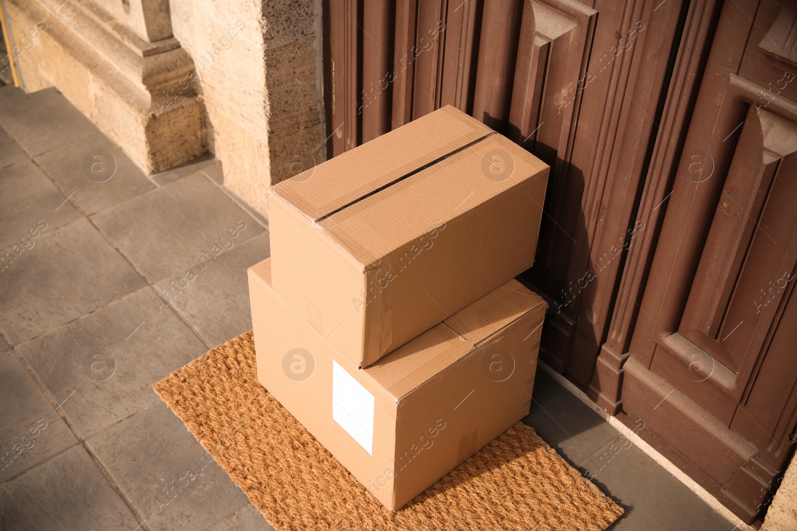 Photo of Delivered parcels on door mat near entrance