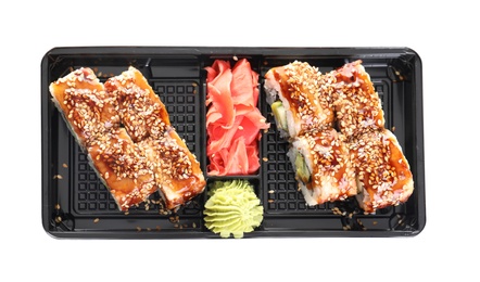 Photo of Box with tasty sushi rolls on white background, top view. Food delivery