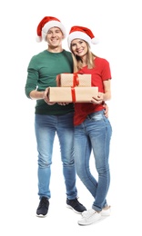 Young couple with Christmas gifts on white background