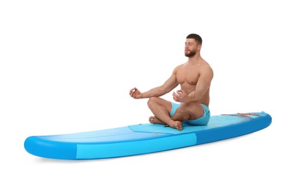 Handsome man practicing yoga on blue SUP board against white background