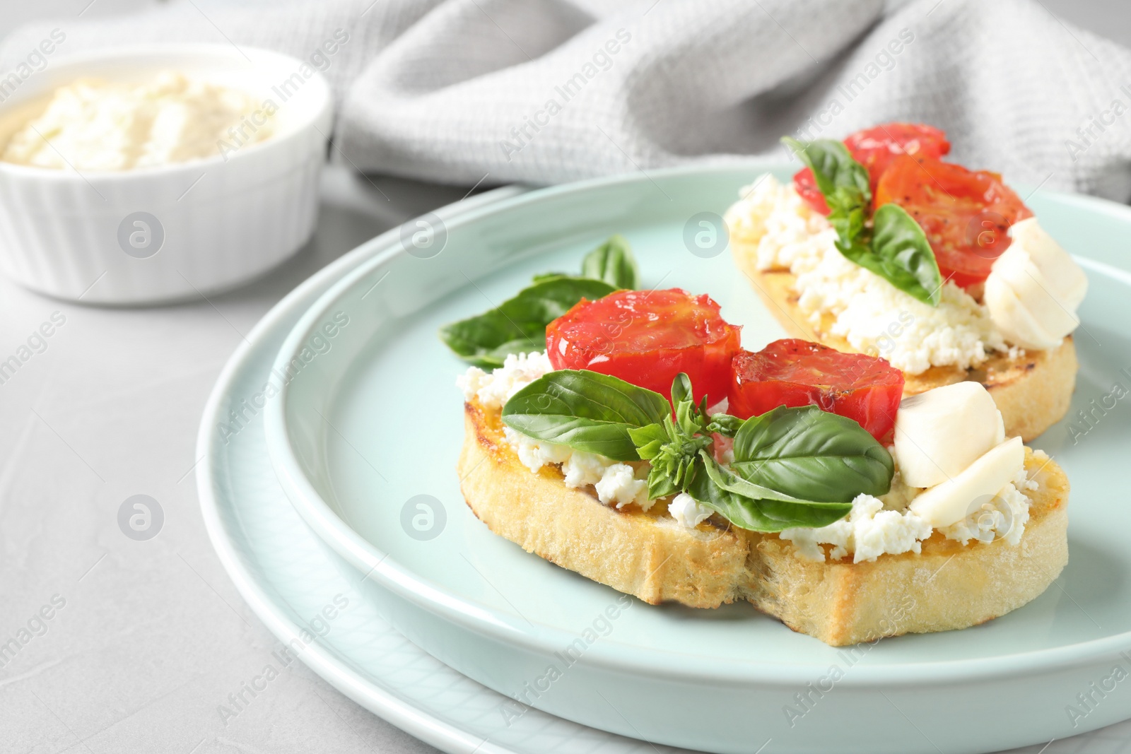 Photo of Tasty fresh tomato bruschettas on grey table