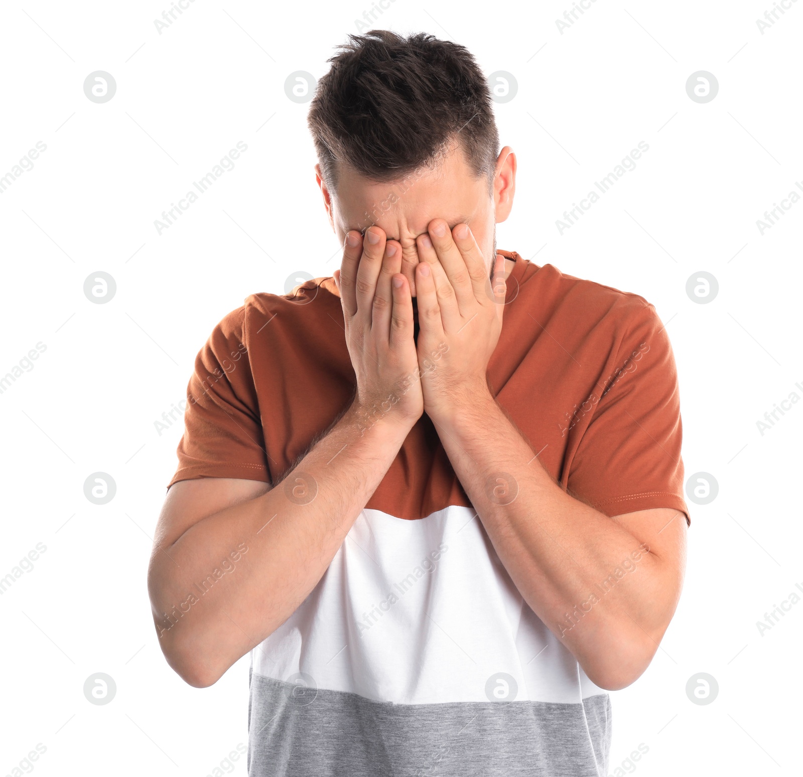 Photo of Man covering eyes while being blinded on white background