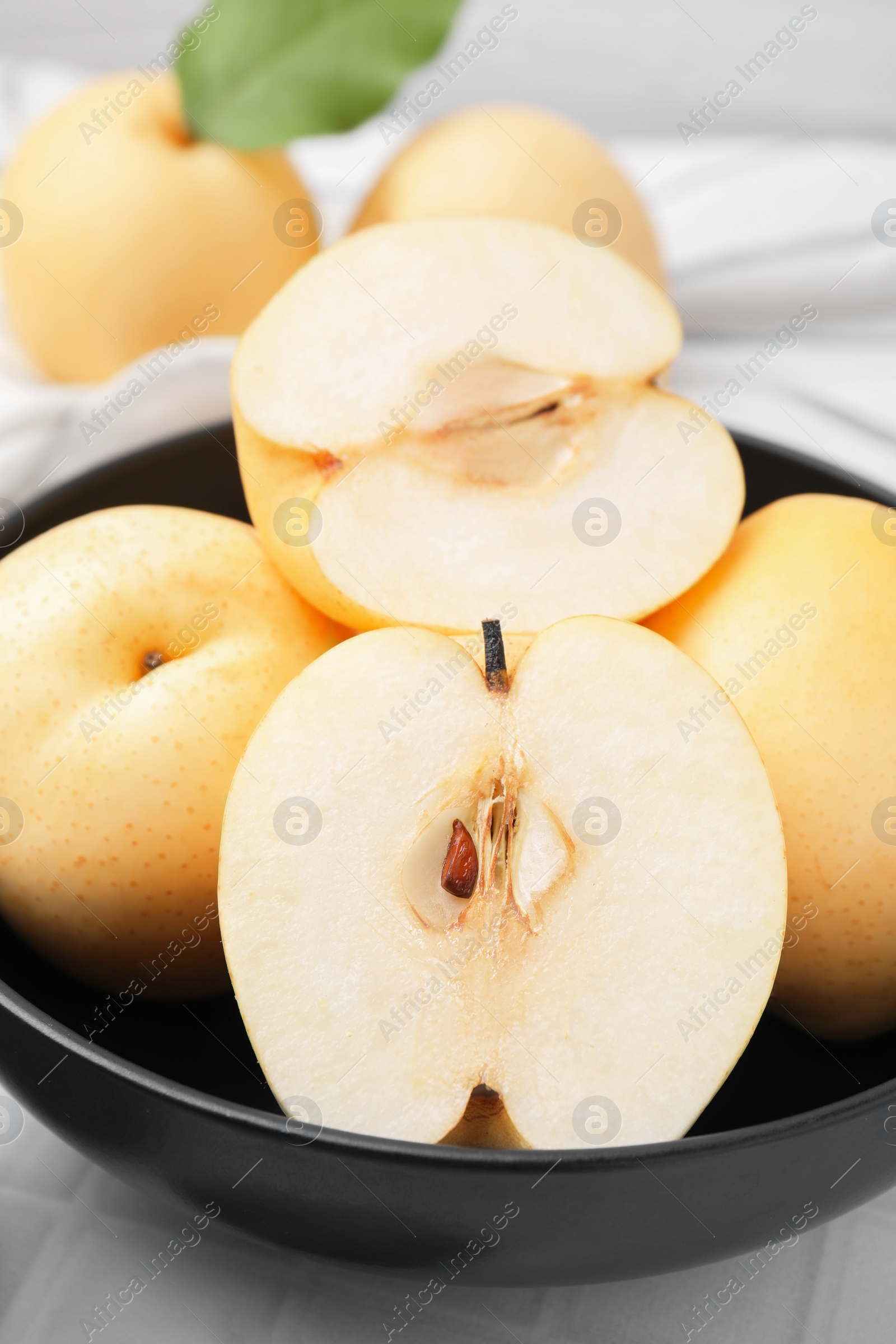 Photo of Delicious apple pears on white tiled table, closeup