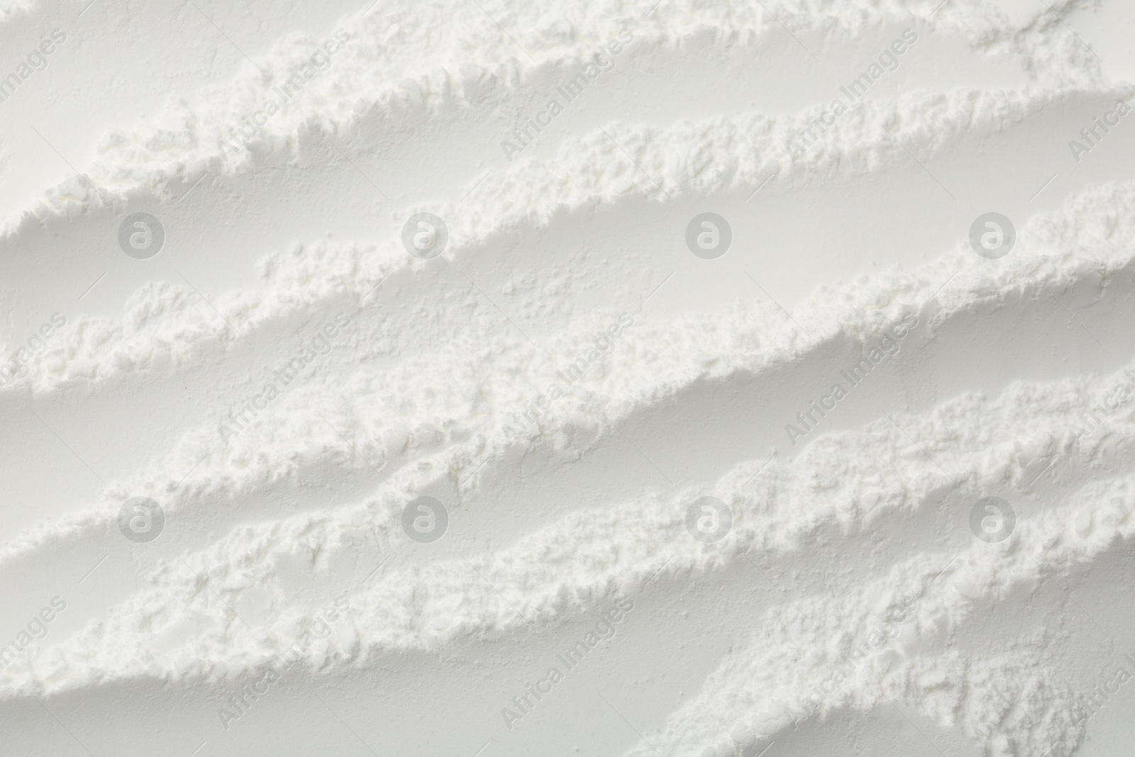 Photo of Texture of baking powder as background, top view