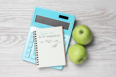 Photo of Notebook with calculated glycemic load for apples, calculator and fresh fruits on light wooden table, flat lay