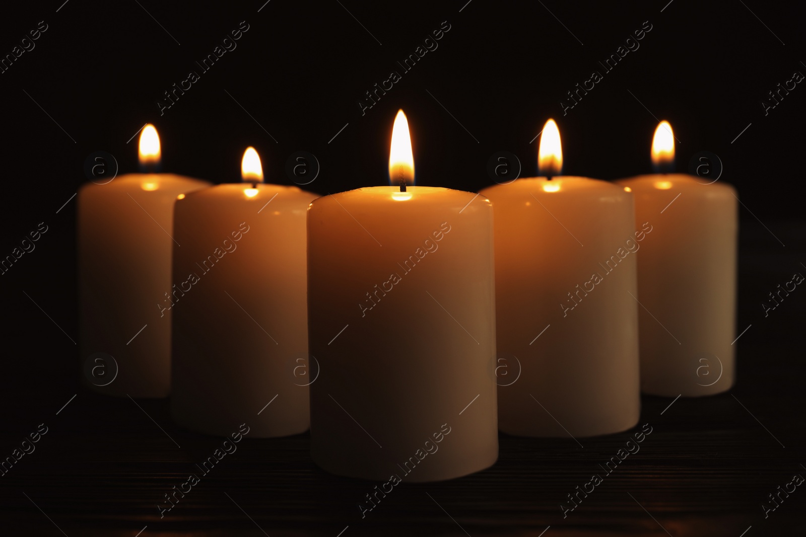 Photo of Burning candles on dark background. Memory day