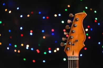 Photo of Guitar against blurred lights. Christmas music concept