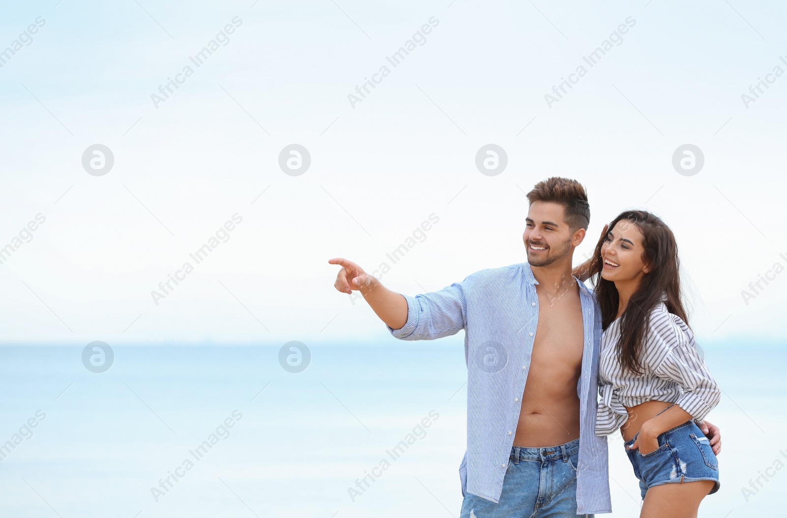 Photo of Happy young couple spending time together on beach