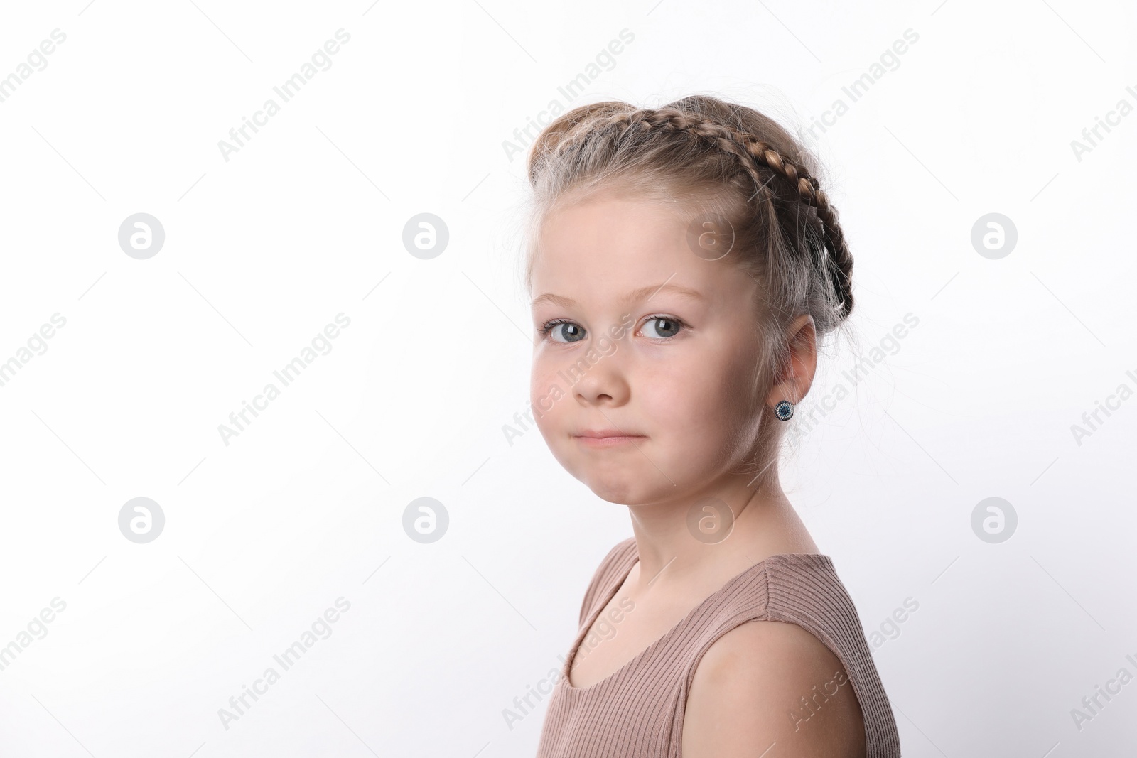 Photo of Little girl with braided hair on white background. Space for text