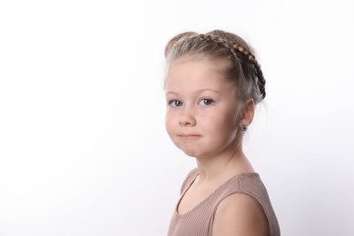 Photo of Little girl with braided hair on white background. Space for text