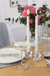 Photo of Romantic table setting with candles and flowers