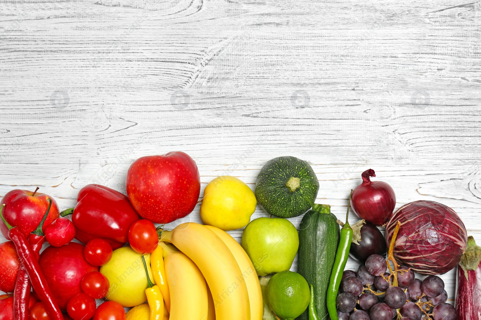 Photo of Rainbow composition with fresh vegetables and fruits on wooden background, flat lay