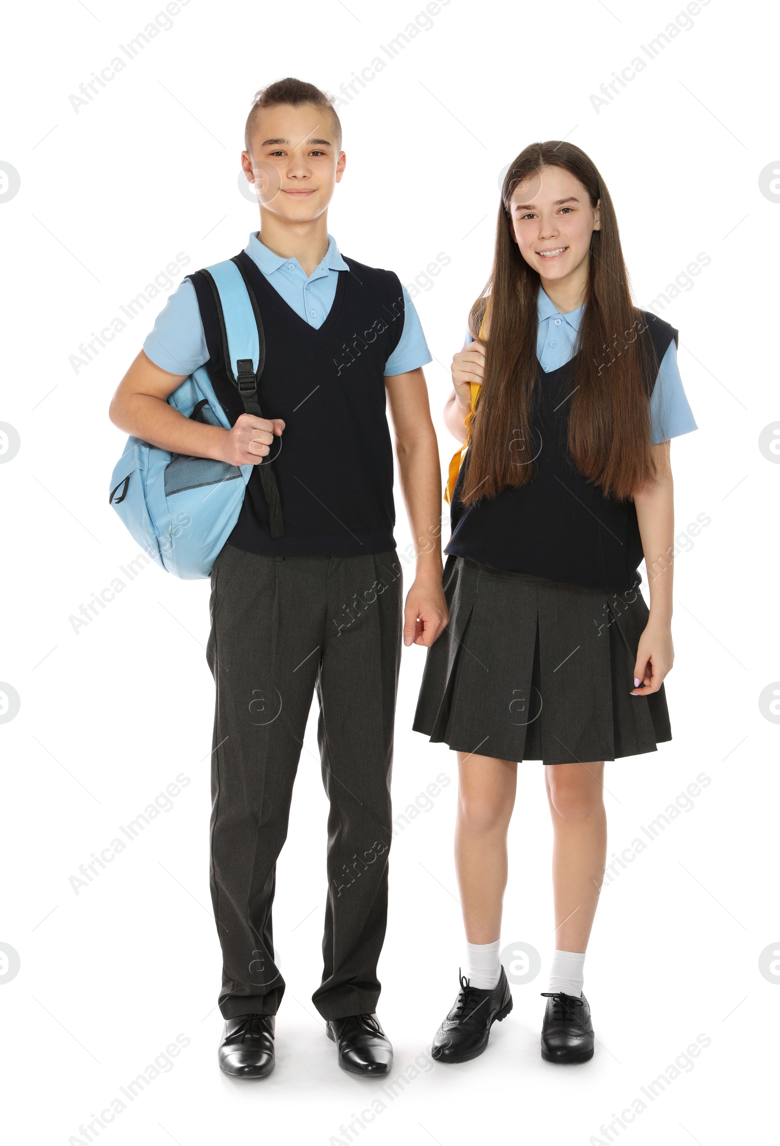 Photo of Full length portrait of teenagers in school uniform with backpacks on white background