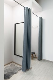 Photo of Dressing rooms in fashion store. Interior design