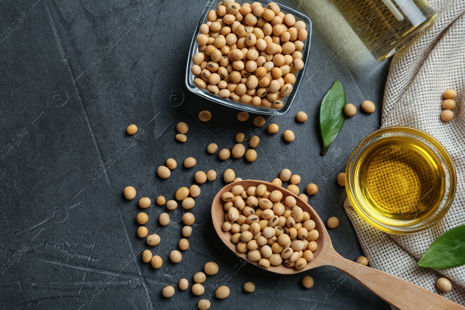 Photo of Flat lay composition with soybean oil on grey table