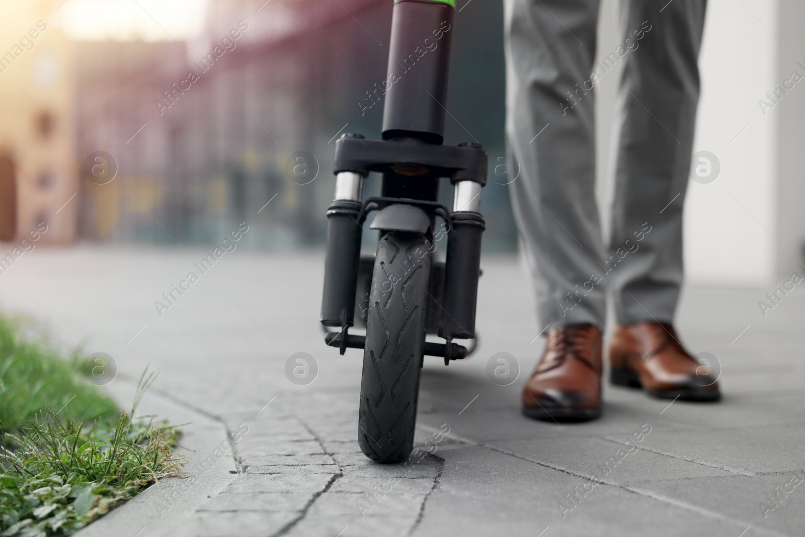 Photo of Businessman with modern kick scooter on city street, closeup. Space for text