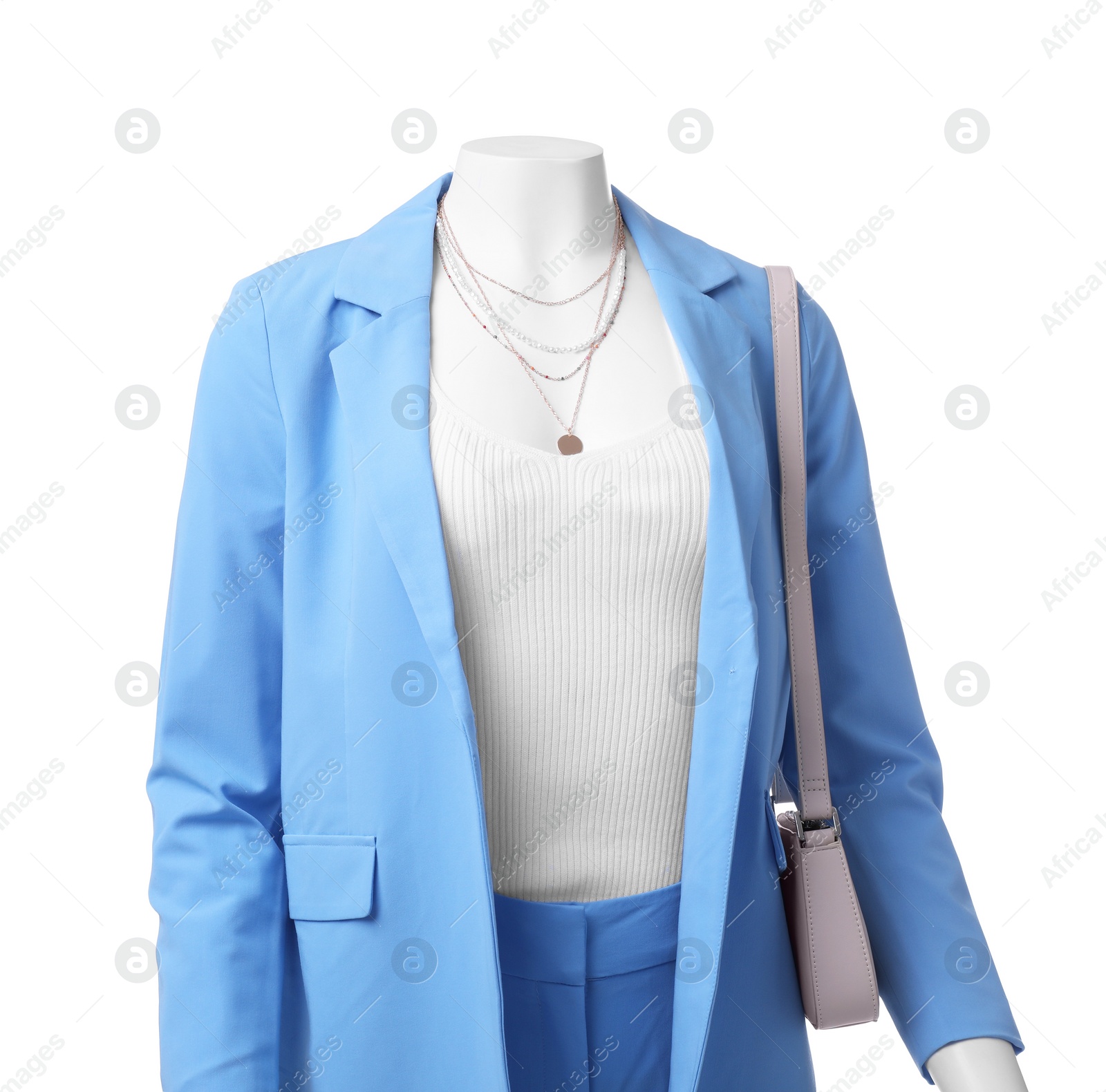 Photo of Female mannequin dressed in light blue suit and top with accessories isolated on white. Stylish outfit