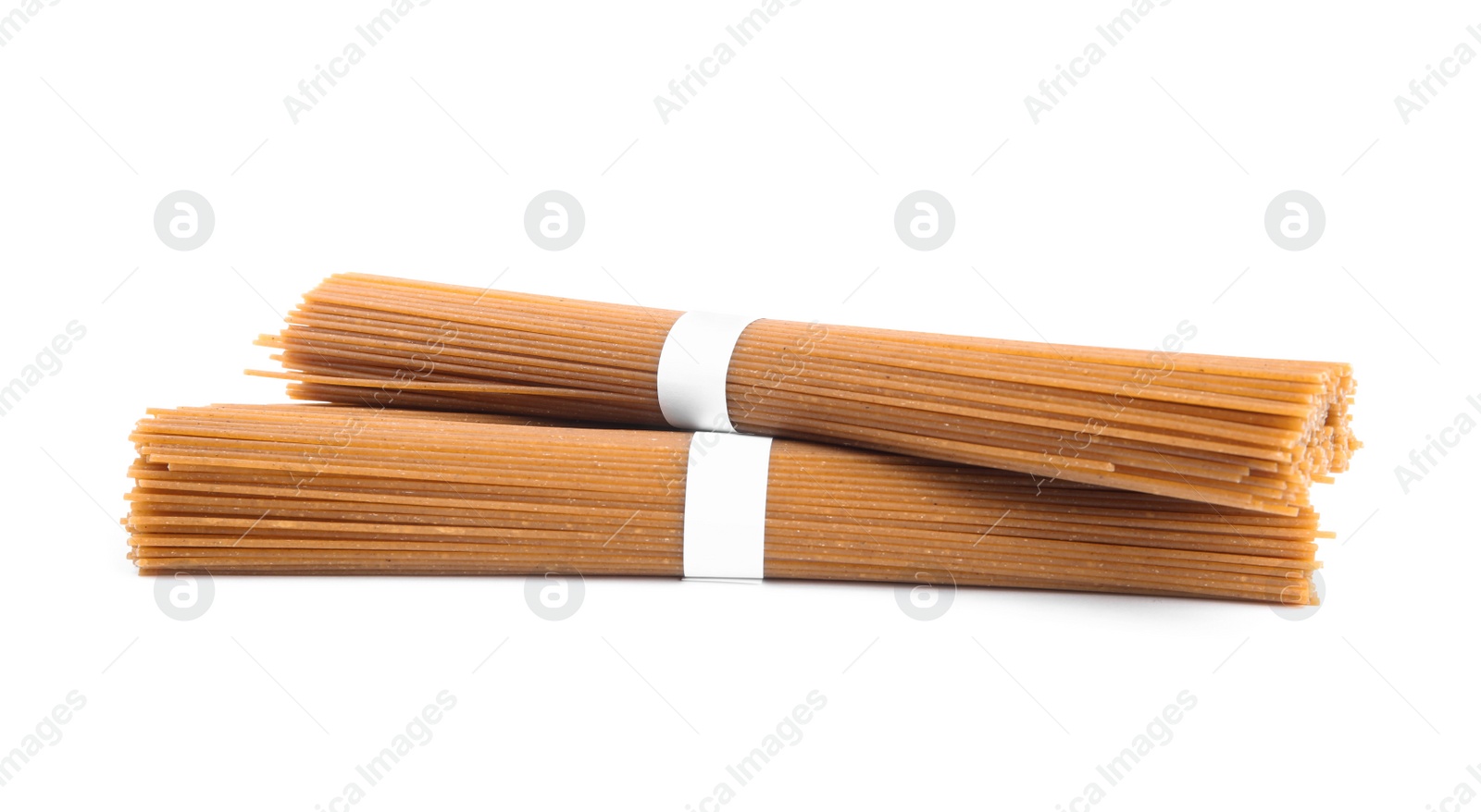 Photo of Uncooked buckwheat noodles isolated on white. Japanese cuisine