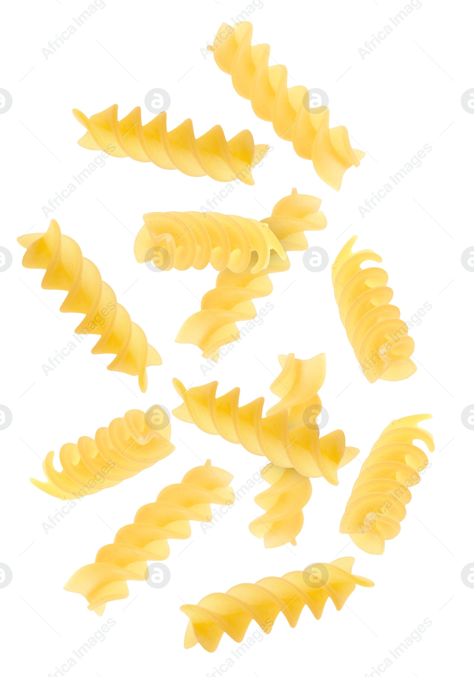 Image of Raw fusilli pasta flying on white background