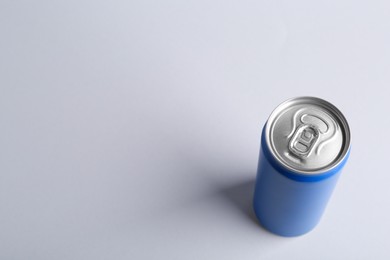 Photo of Energy drink in blue can on light grey background, above view. Space for text