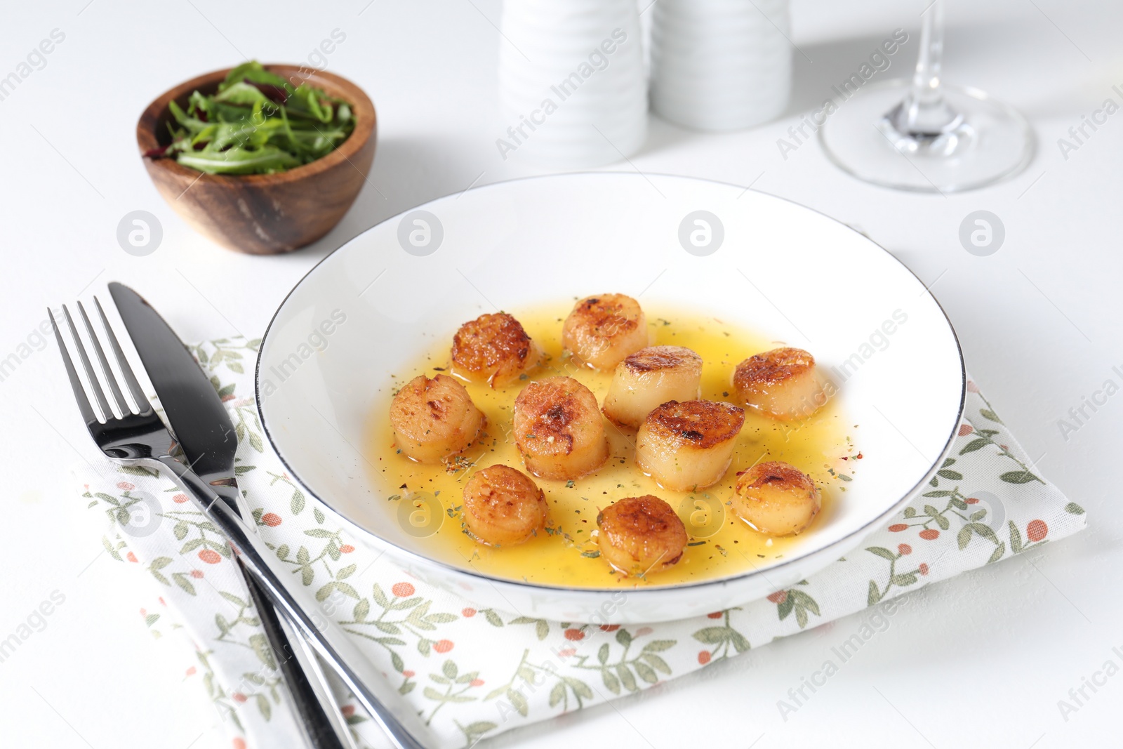 Photo of Delicious fried scallops served on white table