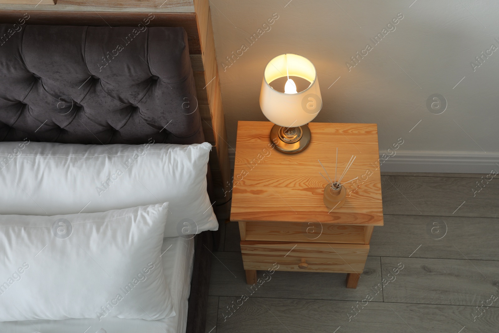 Photo of Stylish room interior with comfortable bed and nightstand, above view