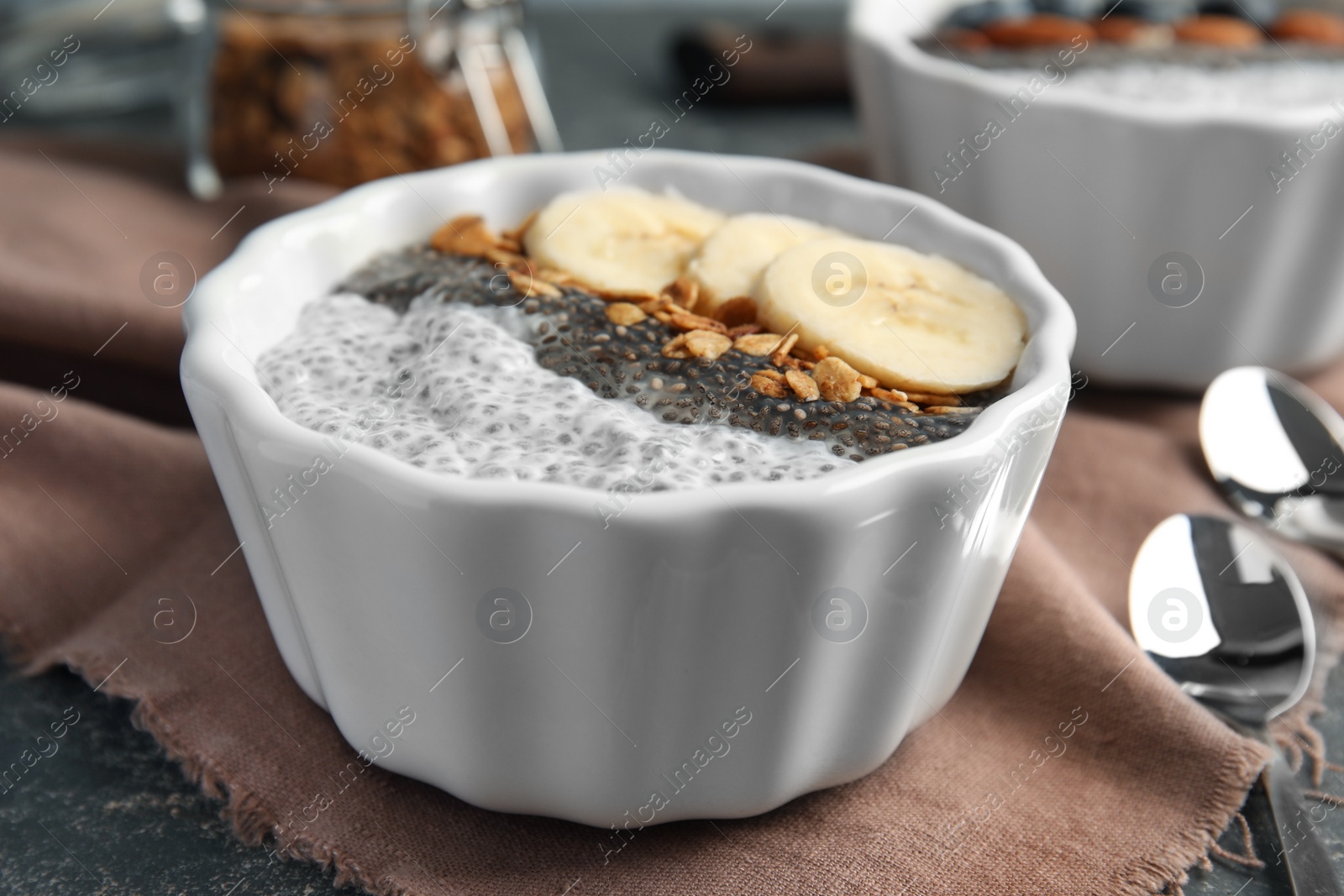 Photo of Tasty chia seed pudding with banana and granola served on table