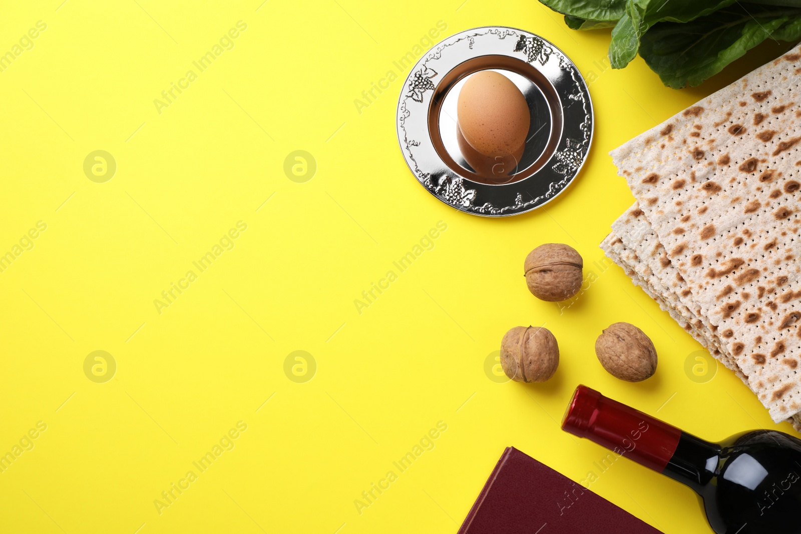 Photo of Flat lay composition with symbolic Pesach (Passover Seder) items on yellow background, space for text