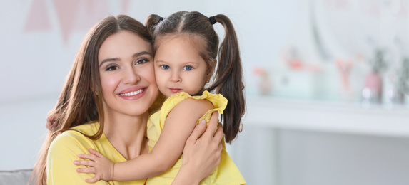 Image of Young mother with little daughter at home. Banner design