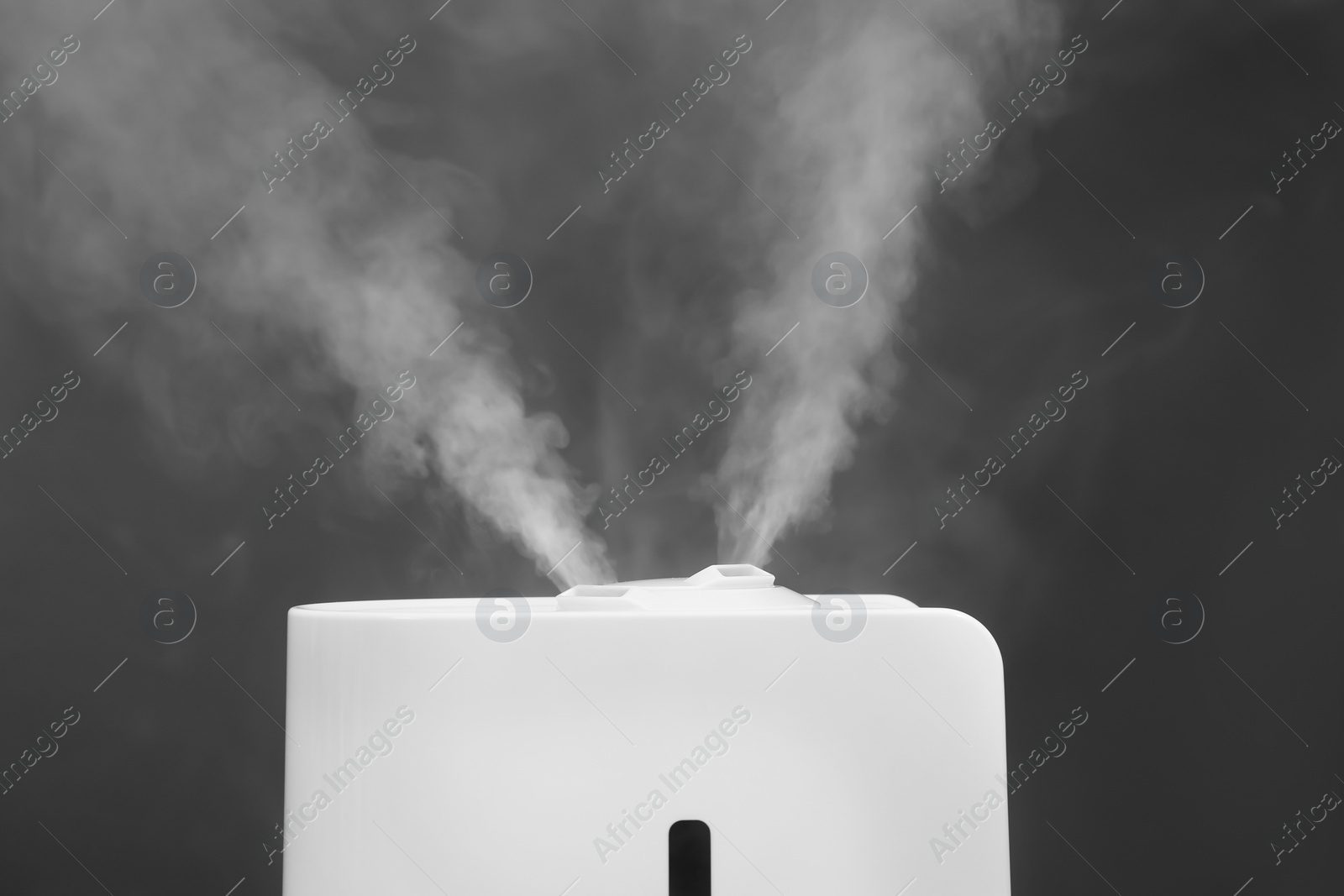 Photo of Modern air humidifier on grey background, closeup
