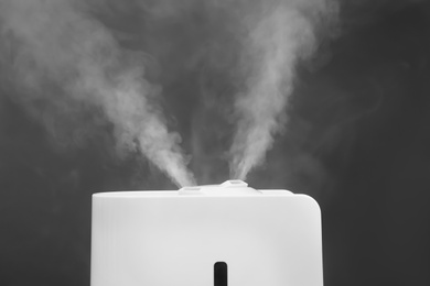 Modern air humidifier on grey background, closeup
